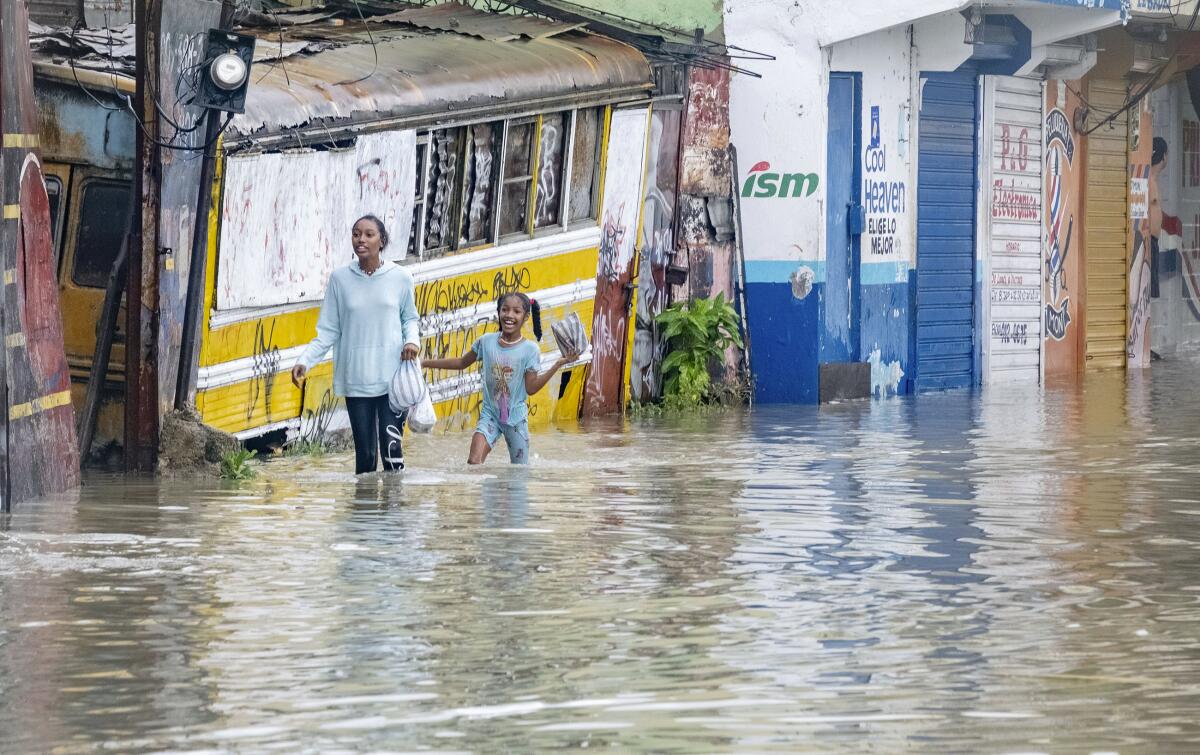 People wading through a flooded street