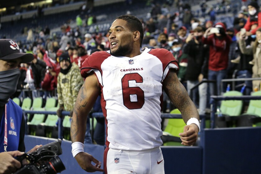 Arizona Cardinals' James Conner smiles as he heads off the field after his team defeated the Seattle Seahawks in an NFL football game, Sunday, Nov. 21, 2021, in Seattle. (AP Photo/John Froschauer)