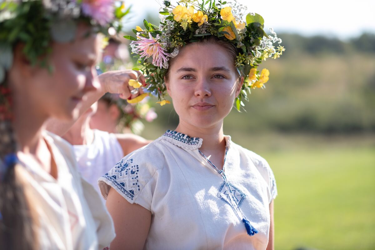 Florence Pugh and the cast participate in the May Queen Dance in the film “Midsommar."