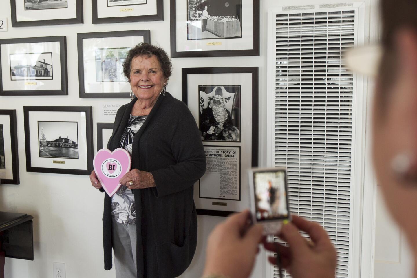Sharon Lambert takes the photo of Marcia Working who wrote a love letter about Balboa Island at the Balboa Island Museum & Historical Society on Saturday, February 15. (Scott Smeltzer, Daily Pilot)