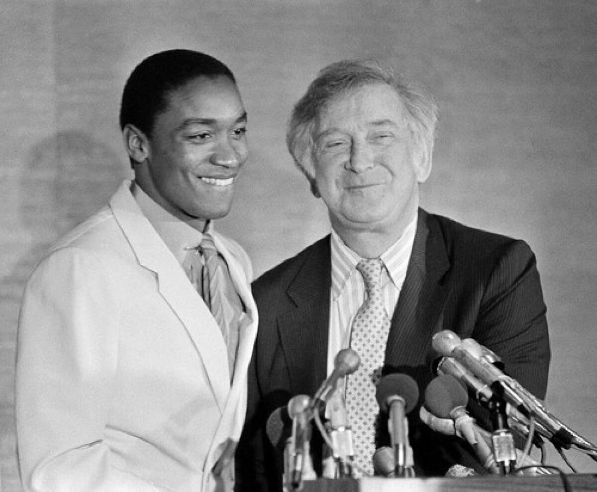 Bill Davidson and Isiah Thomas talk to reporters in 1984 after Davidson announced that Thomas' contract had been extended for 10 years.