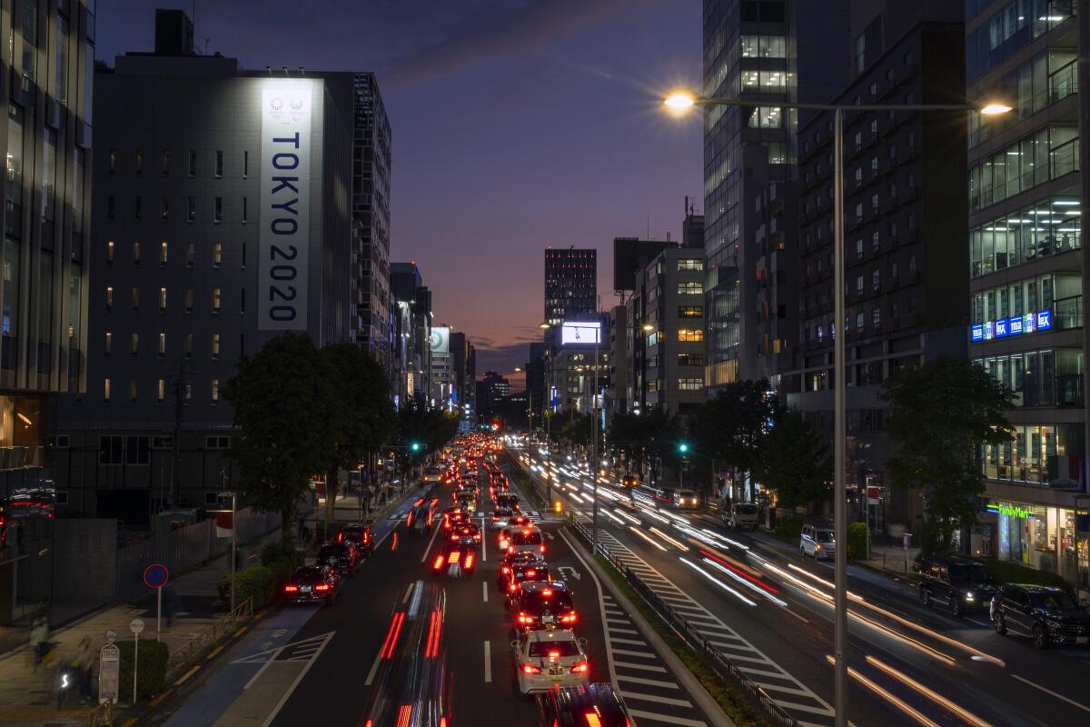 Traffic flows through a business district in Tokyo.