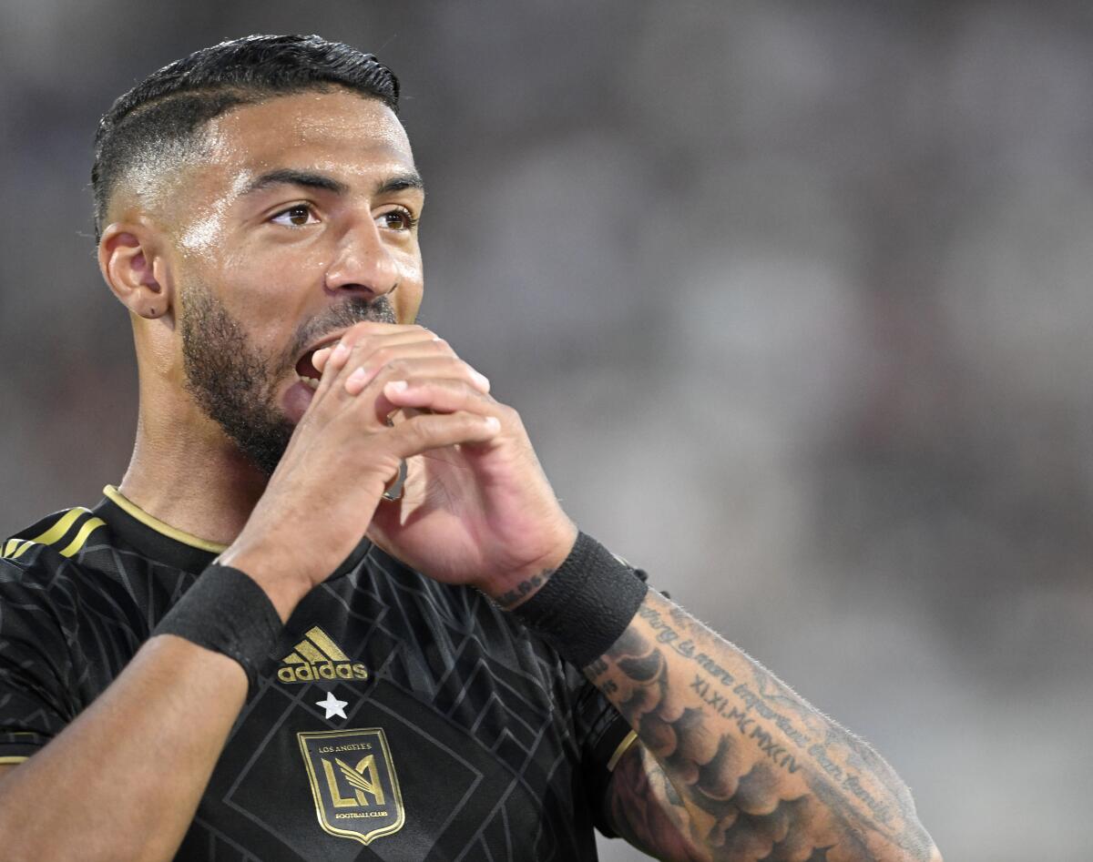 LAFC forward Denis Bouanga holds his hands in front of his mouth.