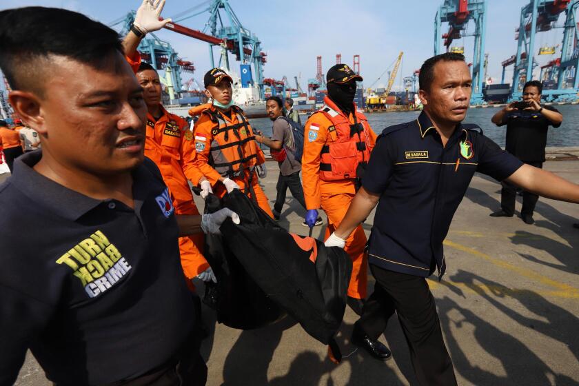 Members of a rescue team transfer body bags after remains are recovered from the sea where Lion Air flight JT 610 crashed northeast of Jakarta, Indonesia, earlier in the day.