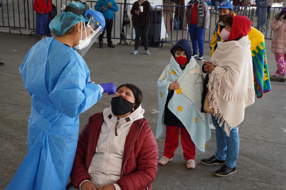 Families line up last week for COVID-19 tests at a testing center in Mexico City's Iztapalapa district.