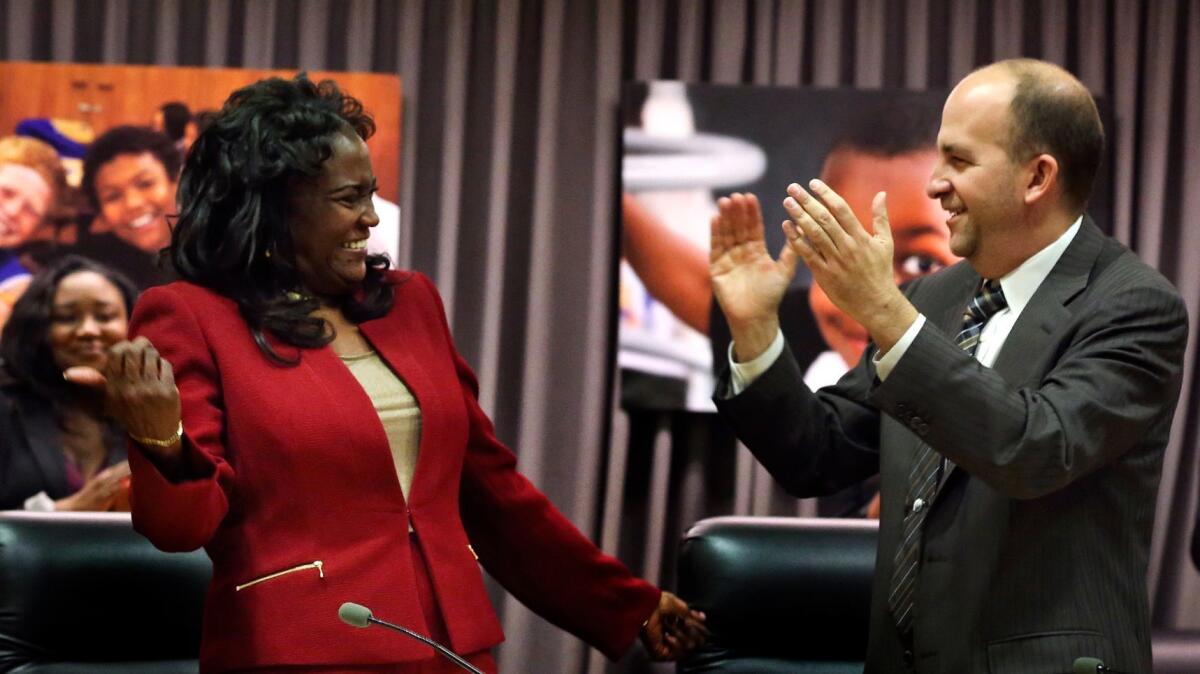 Supt. Michelle King, left, receives applause from Los Angeles school board President Steve Zimmer after her hire in January 2016.