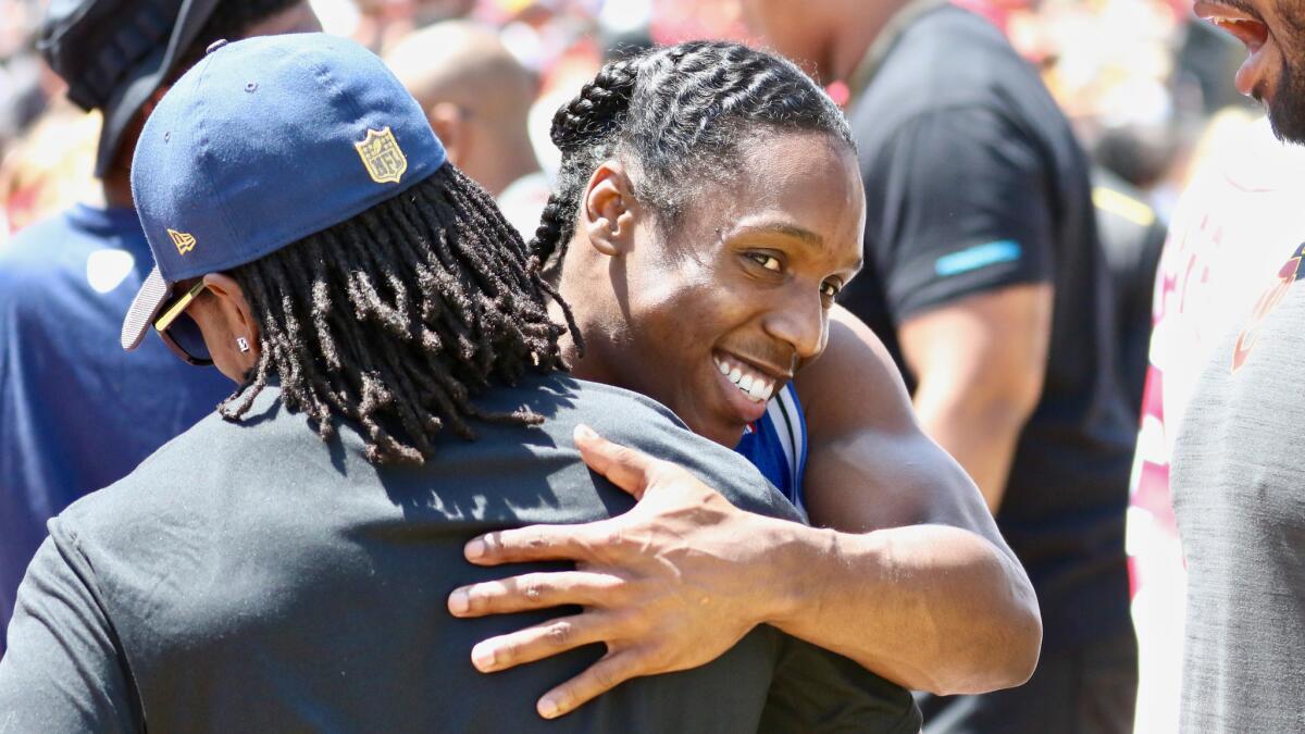 Adoree' Jackson shares a hug with new Rams cornerback Nickell Robey-Coleman during USC's spring game Saturday.