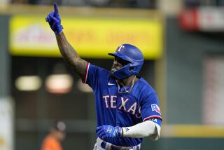 Texas Rangers' Adolis Garcia reacts after hitting a grand slam during the ninth inning.