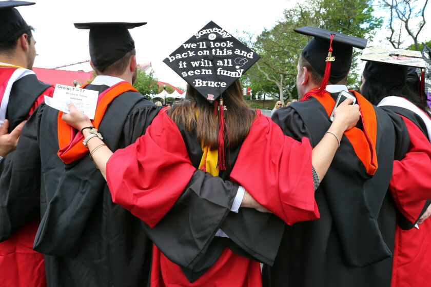 Students embrace as they arrive for the Rutgers graduation ceremonies in Piscataway, N.J. on May 15.