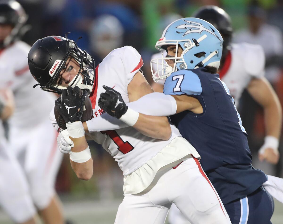 Corona del Mar's Ryan Rakunas (7) makes a hard hit on San Clemente's Cole Herlean after a catch on Friday night.