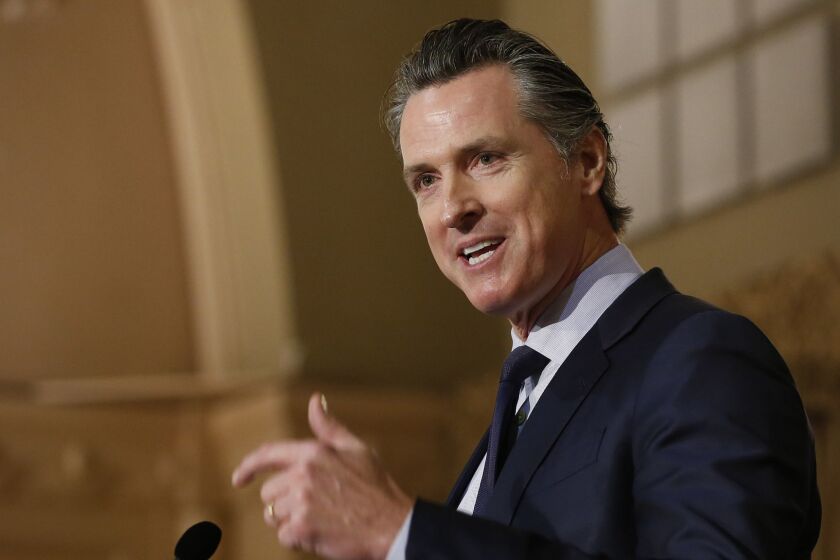 FILE - In This Jan. 17, 2019, file photo, California Gov. Gavin Newsom speaks at the California Legislative Black Caucus Martin Luther King Jr., Breakfast in Sacramento, Calif. Newsom's administration is using a new law for the first time in an attempt to force Southern California's self-styled "Surf City USA" to meet housing goals. The administration on Friday, Jan. 25, 2019, said it is suing Huntington Beach under the law that took effect Jan. 1. The measure was passed in 2017 as part of a package of bills intended to address the state's severe housing shortage and homelessness problem. (AP Photo/Rich Pedroncelli,File)