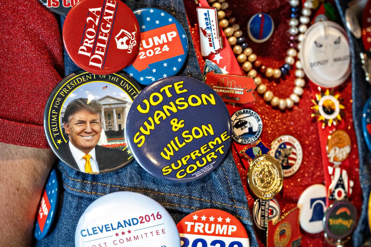  Susan Reneau wears a collection of Trump buttons 