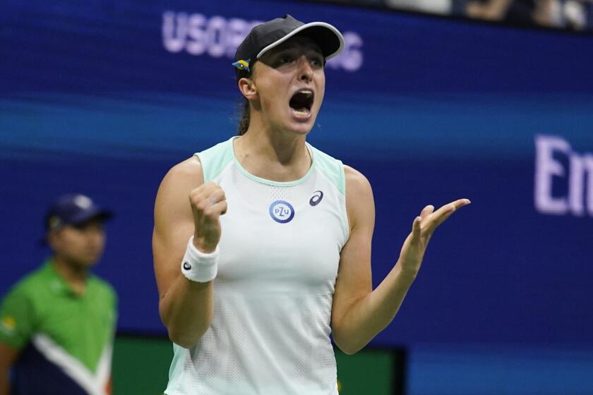 Iga Swiatek, of Poland, reacts after defeating Aryna Sabalenka, of Belarus.