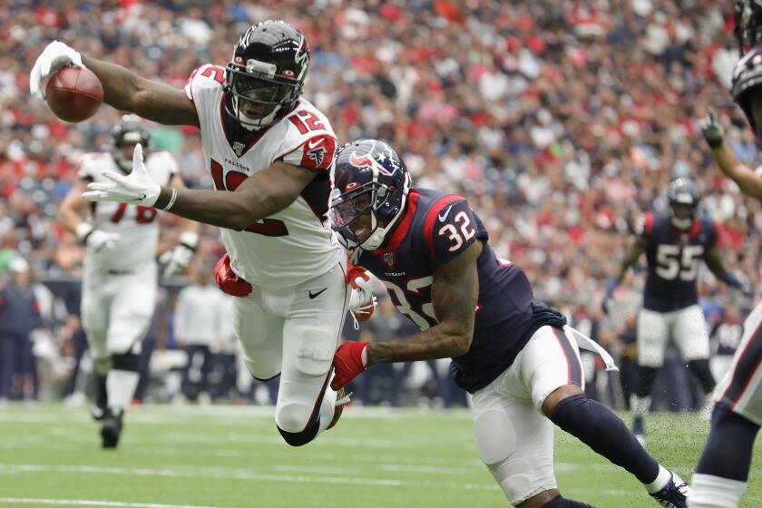 HOUSTON, TX - OCTOBER 06: Mohamed Sanu #12 of the Atlanta Falcons dives for a touchdown defended by Lonnie Johnson #32 of the Houston Texans in the first quarter at NRG Stadium on October 6, 2019 in Houston, Texas. (Photo by Tim Warner/Getty Images)