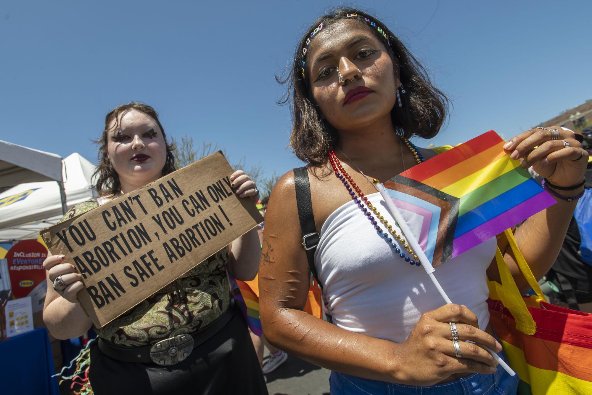 Elleana Tanner, left, of Laguna Hills and Alejandra Barba of Orange attend the OC Pride festival.