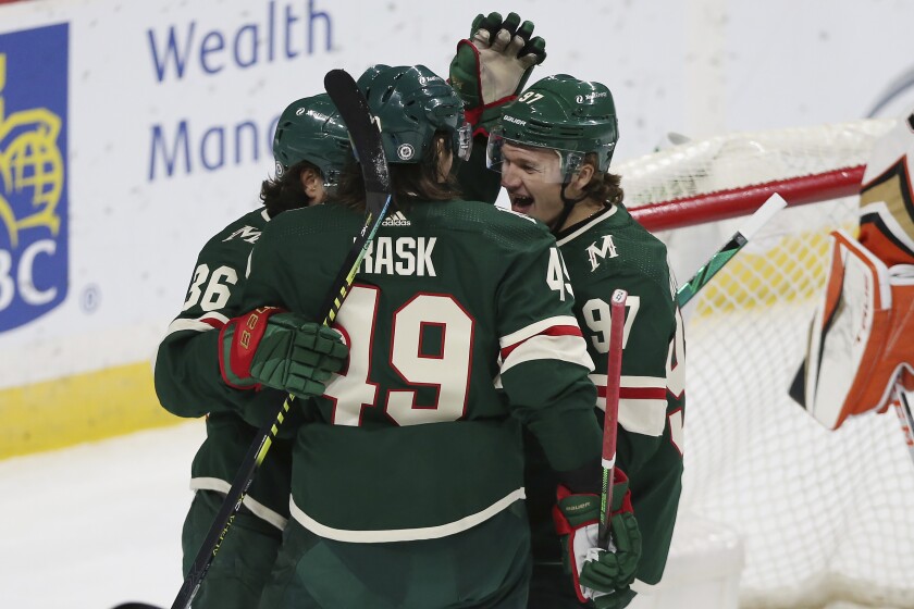 Minnesota Wild's Victor Rask (49) celebrates with teammates Mats Zuccarello (36) and Kirill Kaprizov (97) after scoring a goal against the Anaheim Ducks during the first period of an NHL hockey game Friday, May 7, 2021, in St. Paul, Minn. (AP Photo/Stacy Bengs)