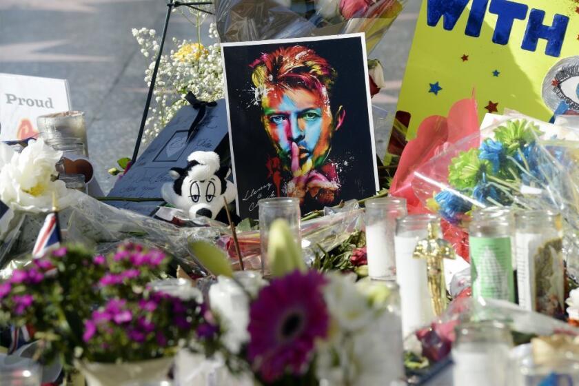 A memorial for David Bowie grows at his star on the Hollywood Walk of Fame.