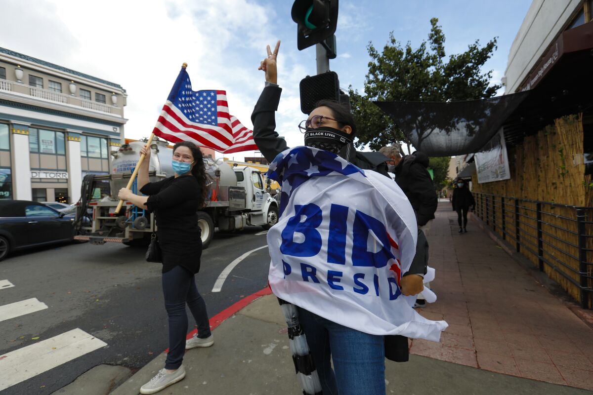Frida Espinoza celebrate Joe Biden's win wrapped in Biden flag in Hillcrest.