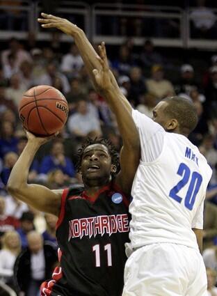 Northridge's Rodrigue Mels tries to go under the block attempt of Memphis' Doneal Mack in the first half Thursday.