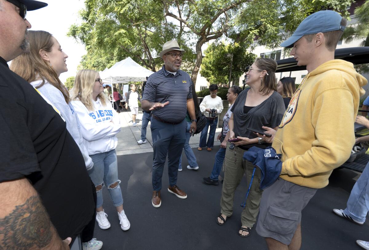 UCI Vice Chancellor for Student Affairs Willie Banks, center, chats with families.