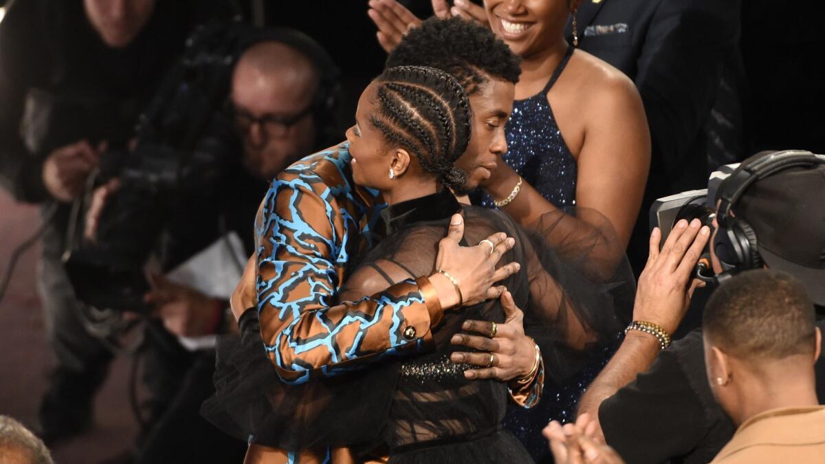 Chadwick Boseman congratulates Letitia Wright before she goes onstage to accept the award for breakthrough performance in a motion picture for "Black Panther" at Saturday night's NAACP Image Awards.