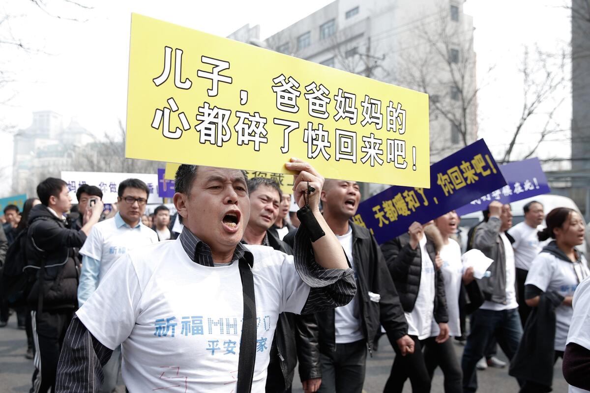 Relatives of some of the passengers who went missing on Malaysia Airlines Flight 370 demonstrate in Beijing in March.