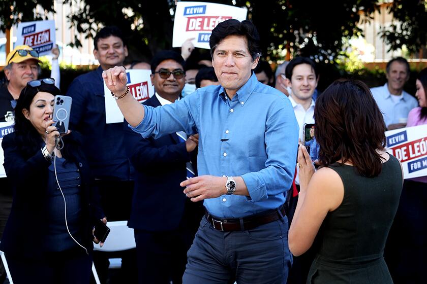 Los Angeles City Councilman Kevin de León, who is running for mayor, with constituents at the grand opening of his campaign headquarters on March 12.