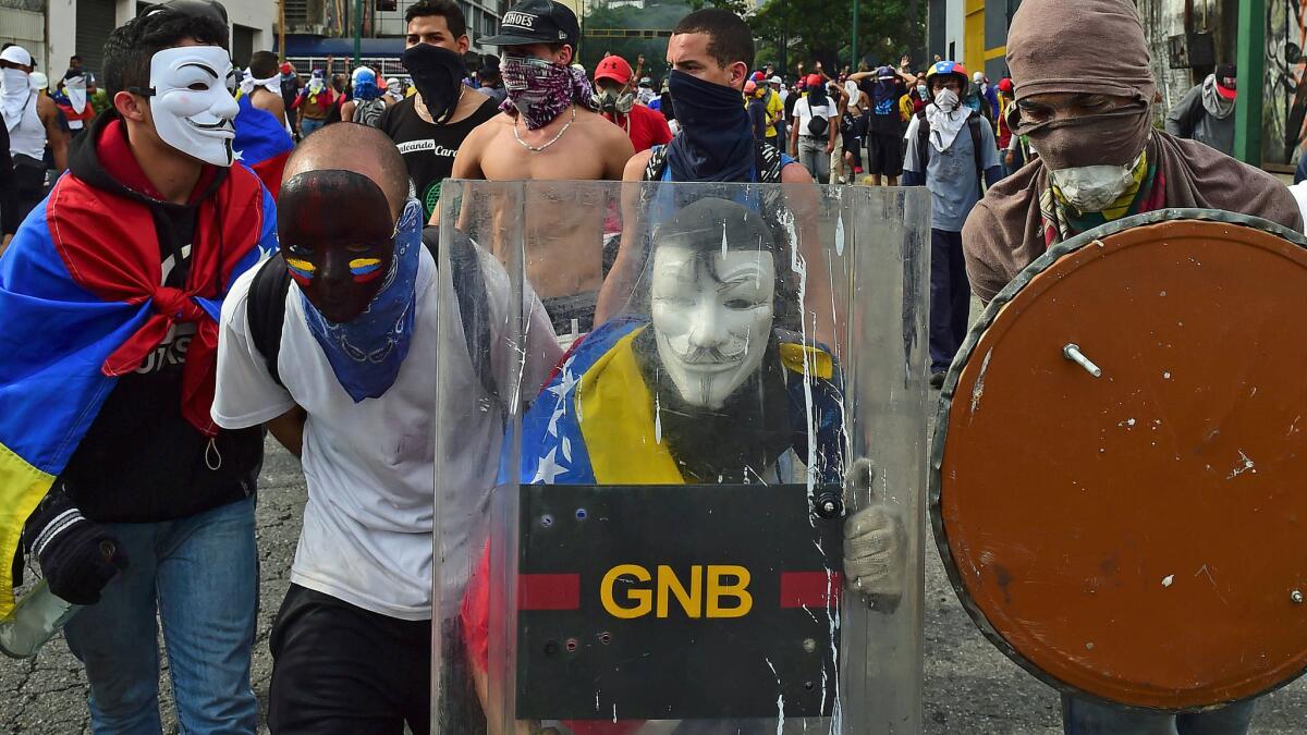 TOPSHOT - Demonstrators protest during a rally against Venezuelan President Nicolas Maduro, in Caracas on April 19, 2017. Venezuela braced for rival demonstrations Wednesday for and against President Nicolas Maduro, whose push to tighten his grip on power has triggered waves of deadly unrest that have escalated the country's political and economic crisis. / AFP PHOTO / RONALDO SCHEMIDTRONALDO SCHEMIDT/AFP/Getty Images ** OUTS - ELSENT, FPG, CM - OUTS * NM, PH, VA if sourced by CT, LA or MoD **