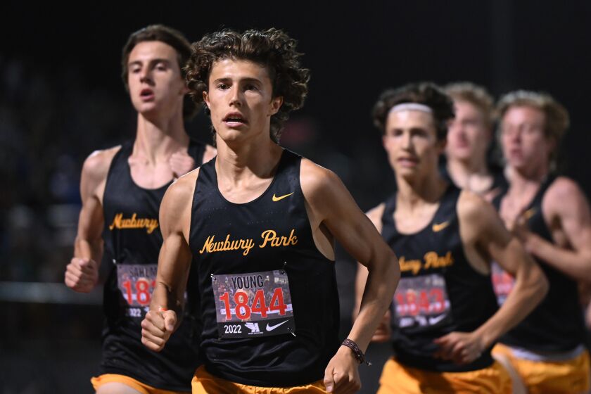 ARCADIA, CA - APRIL 9, 2022: Newbury Park's Lex Young, center, leads teammates Colin Sahlman, left, and Leo Young in the boys' 3200 meter run at the Arcadia track and field invitational. (Michael Owen Baker / For The Times)
