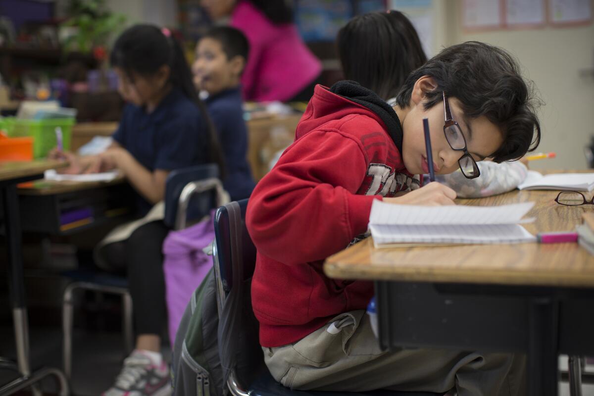 Ramon Hernandez writes in his journal at Gratts Elementary School in Los Angeles.