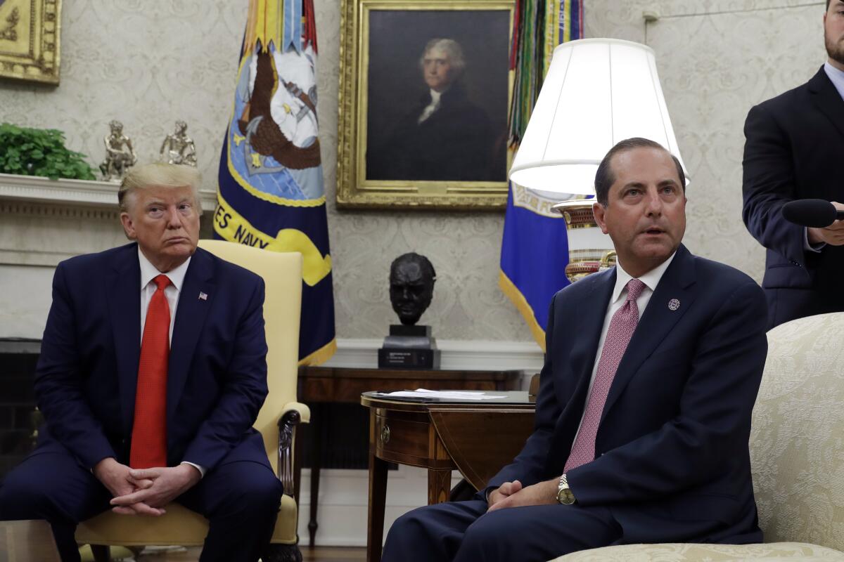 President Donald Trump and Health and Human Services Secretary Alex Azar talk to the media in the Oval Office, Wednesday, Sept. 11, 2019, at the White House in Washington. (AP Photo/Evan Vucci)