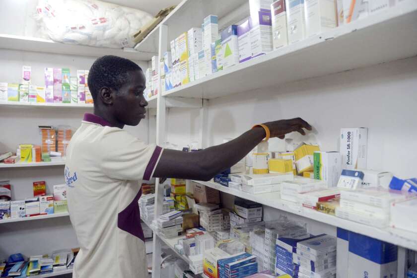 A pharmacist in Lagos, Nigeria, on Saturday, a day after the first confirmed death from the virus in Africa's biggest city.