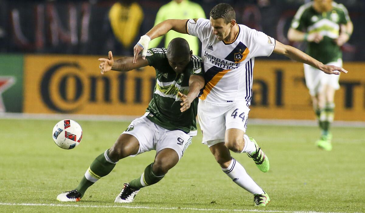 LA Galaxy defender Daniel Steres, right, and Portland Timbers forward Fanendo Adi in action during a game on April 10.