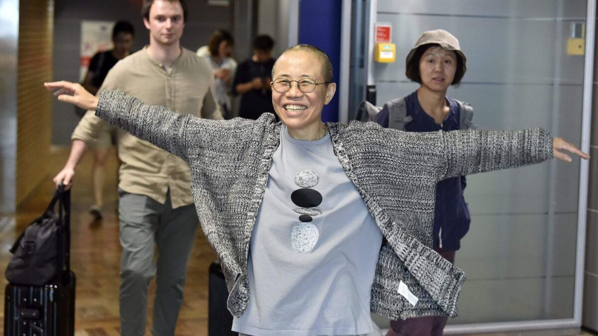 Liu Xia, the widow of Chinese Nobel Peace Prize laureate Liu Xiaobo, smiles as she arrives at the Helsinki International Airport in Finland on Tuesday.