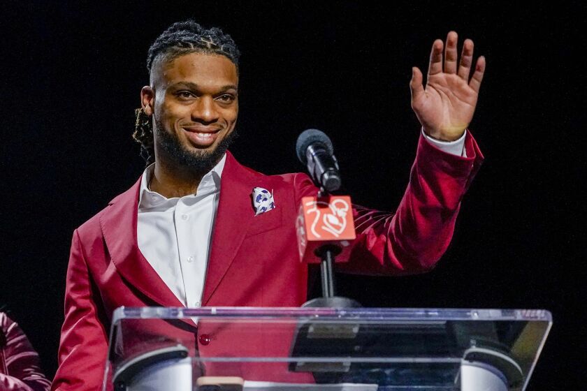 Buffalo Bills' Damar Hamlin waves after being introduced as the winner of the Alan Page Community Award during a news conference ahead of the Super Bowl 57 NFL football game, Wednesday, Feb. 8, 2023, in Phoenix. The Kansas City Chiefs will play the Philadelphia Eagles on Sunday. (AP Photo/Mike Stewart)