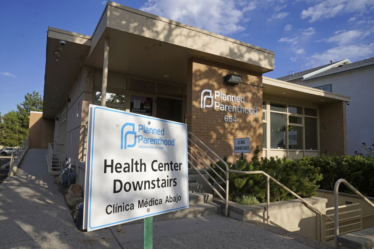 FILE - A sign is shown in front of Planned Parenthood of Utah Tuesday, June 28, 2022, in Salt Lake City. Utah Gov. Spencer Cox signed legislation on Wednesday, March 15, 2023, that will effectively ban clinics from providing abortions, setting off a rush of confusion among clinics, hospitals and prospective patients in the deeply Republican state. With the law set to start taking effect May 3, both the Planned Parenthood Association of Utah and the Utah Hospital Association declined to detail how the increasingly fraught legal landscape for abortion providers in Utah will affect their operations. (AP Photo/Rick Bowmer, File)