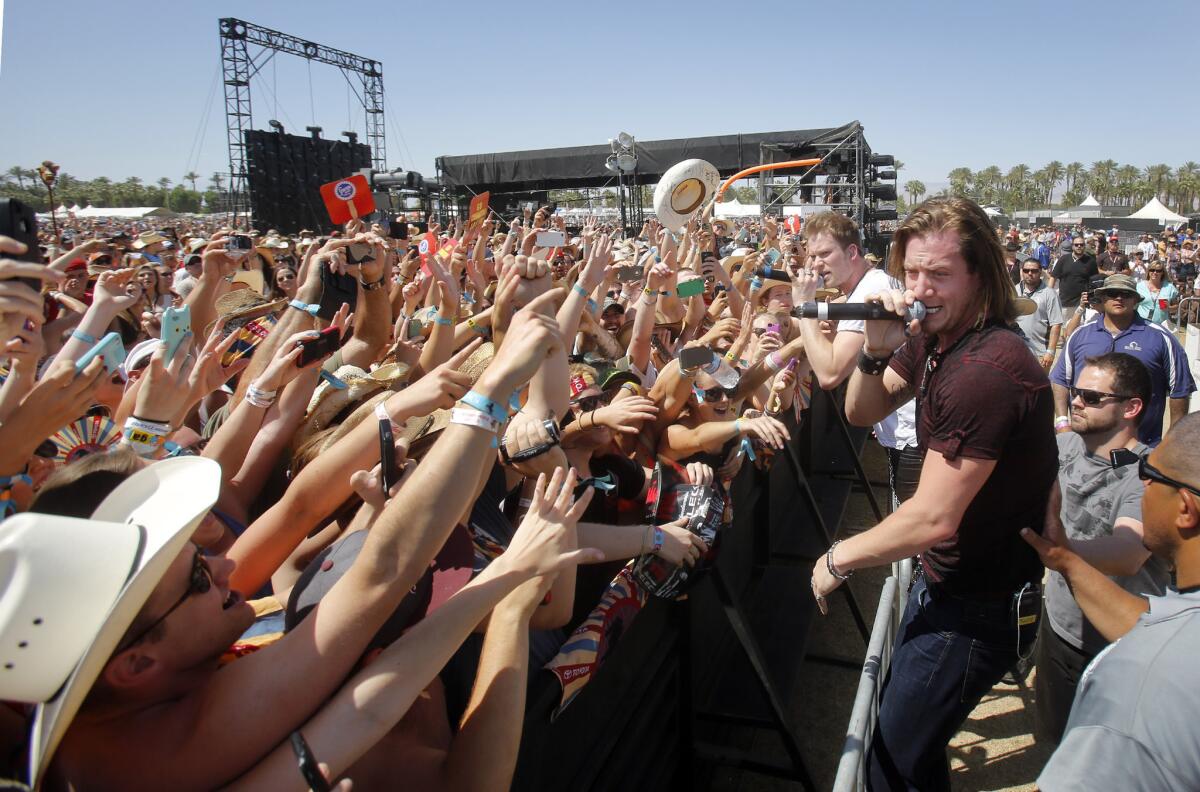 Florida Georgia Line members Brian Kelley, left with microphone, and Tyler Hubbard on Sunday at the Stagecoach Country Music Festival in Indio.