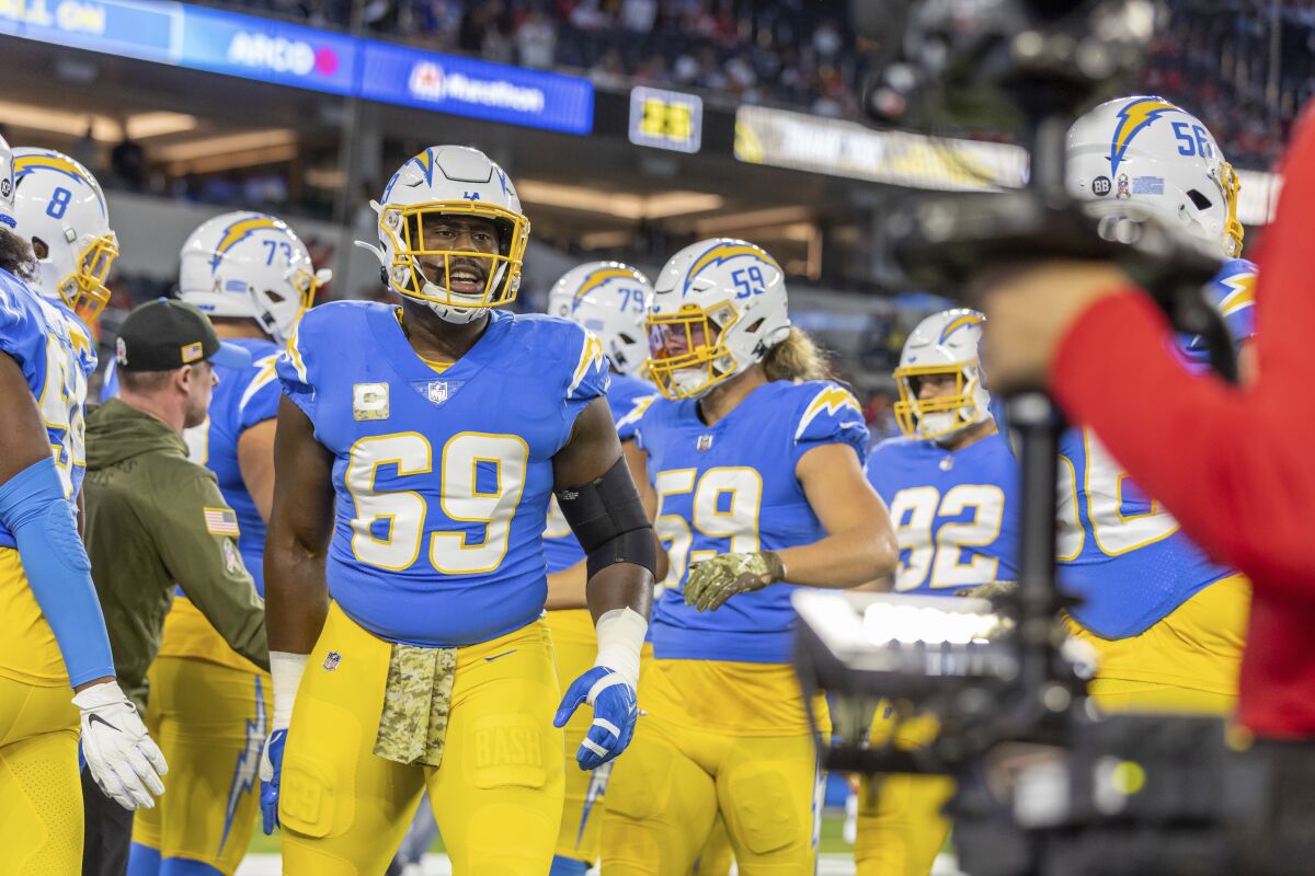 Chargers defensive lineman Sebastian Joseph-Day warms up for a game alongside teammates