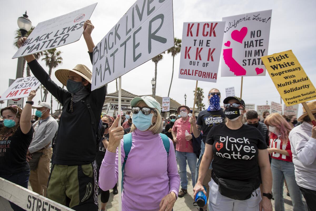 Activists gather for a rally against racial injustice Sunday at the Huntington Beach Pier