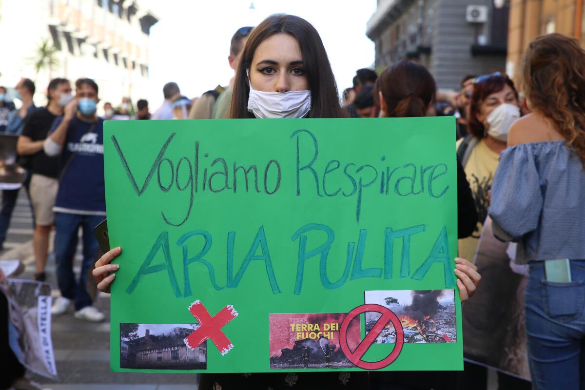 Woman in Milan, Italy, holding banner