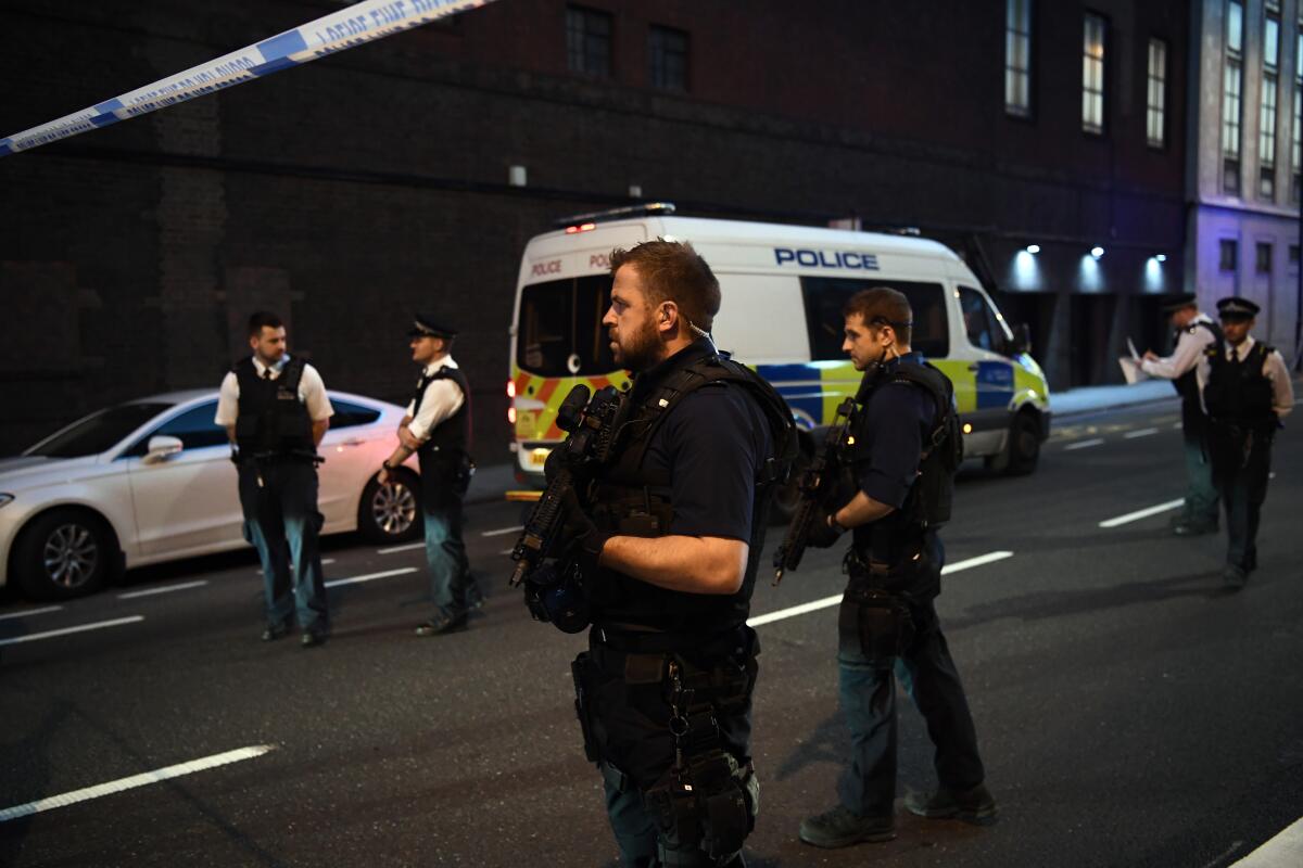 Armed police officers guard a road leading to Finsbury Park Mosque in London.
