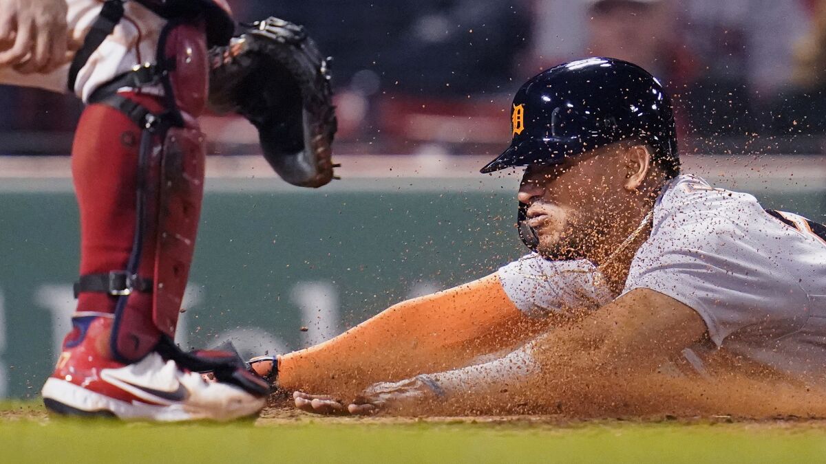 Detroit Tigers' Reyes slides head first into home while scoring on an RBI double by Robbie Grossman during the fifth inning of a baseball game against the Boston Red Sox at Fenway Park, Tuesday, May 4, 2021, in Boston. (AP Photo/Charles Krupa)