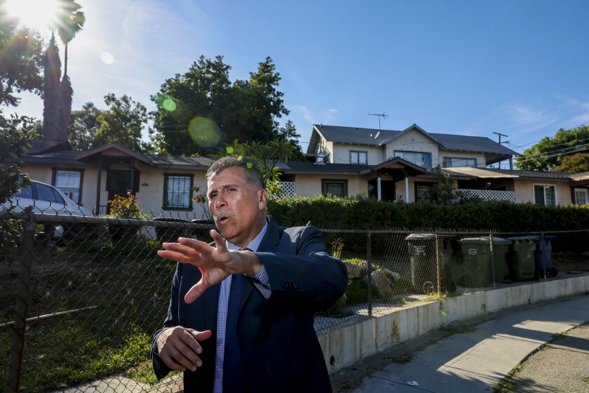 East Los Angeles, CA - September 29: L.A. County Sheriff candidate Robert Luna stands outside his childhood home and talks about his childhood memories in East Los Angeles. Luna says that he first became interested in law enforcement while he was living in this home near Rowan Avenue Elementary School, which he attended for a couple of years before transferring to a local Catholic school. Photo taken in East Los Angeles, Thursday, Sept. 29, 2022. (Allen J. Schaben / Los Angeles Times)