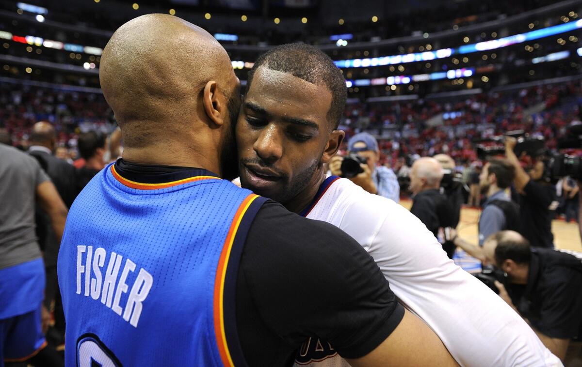 Clippers point guard Chris Paul is embraced by Thunder point guard Derek Fisher after Game 6 of their playoff series.