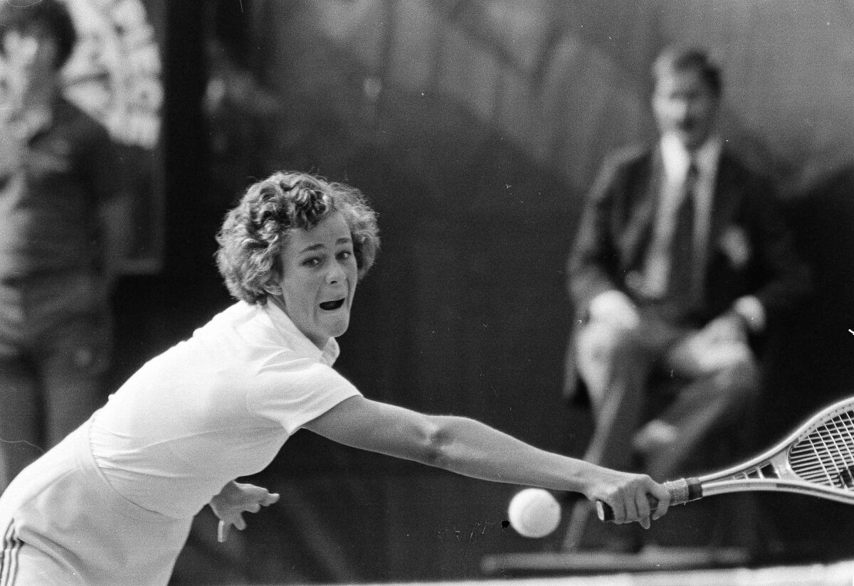 Pam Shriver, 16, grimaces as she pursues a shot by Chris Evert during the women's singles final at the 1978 U.S. Open. 