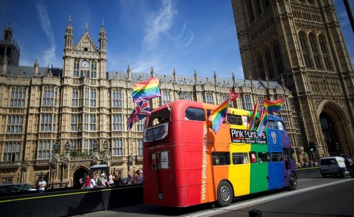 Supporters of same-sex marriage in Britain drive a campaign bus past the Houses of Parliament in London.