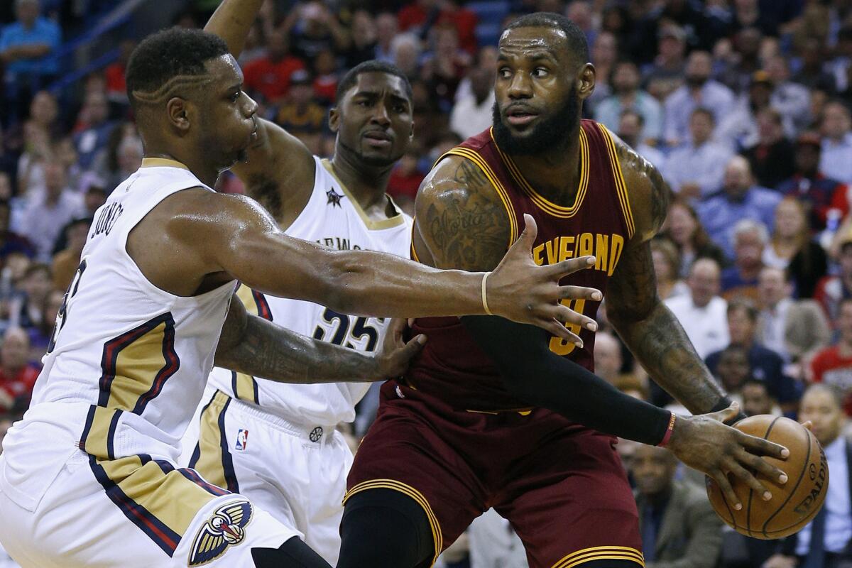 Cavaliers forward LeBron James (23) drives against Pelicans forward Terrence Jones, left, and guard E'Twaun Moore (55) during the first half on Jan. 23.