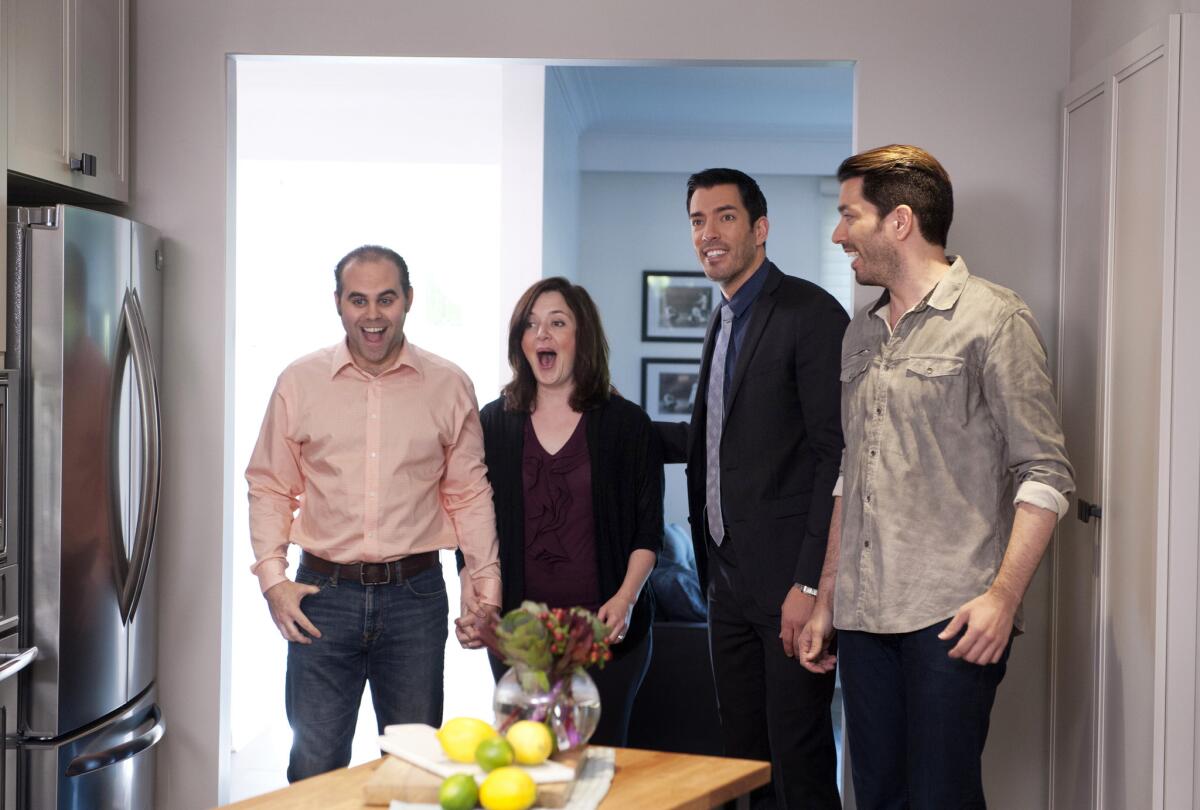 A couple see their new kitchen for the first time as Drew and Jonathan Scott give them a tour on HGTV's "Property Brothers."