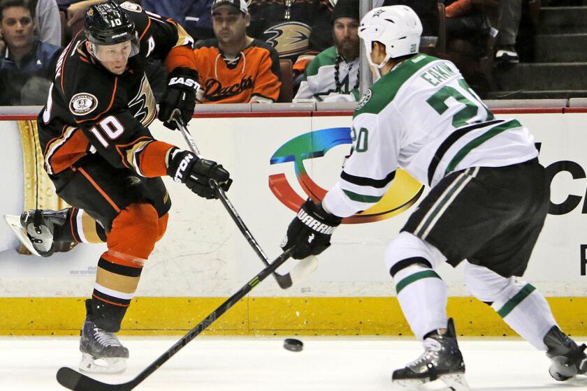 Ducks right wing Corey Perry looks to pass around Dallas Stars center Cody Eakin in the first period at Honda Center on April 8.