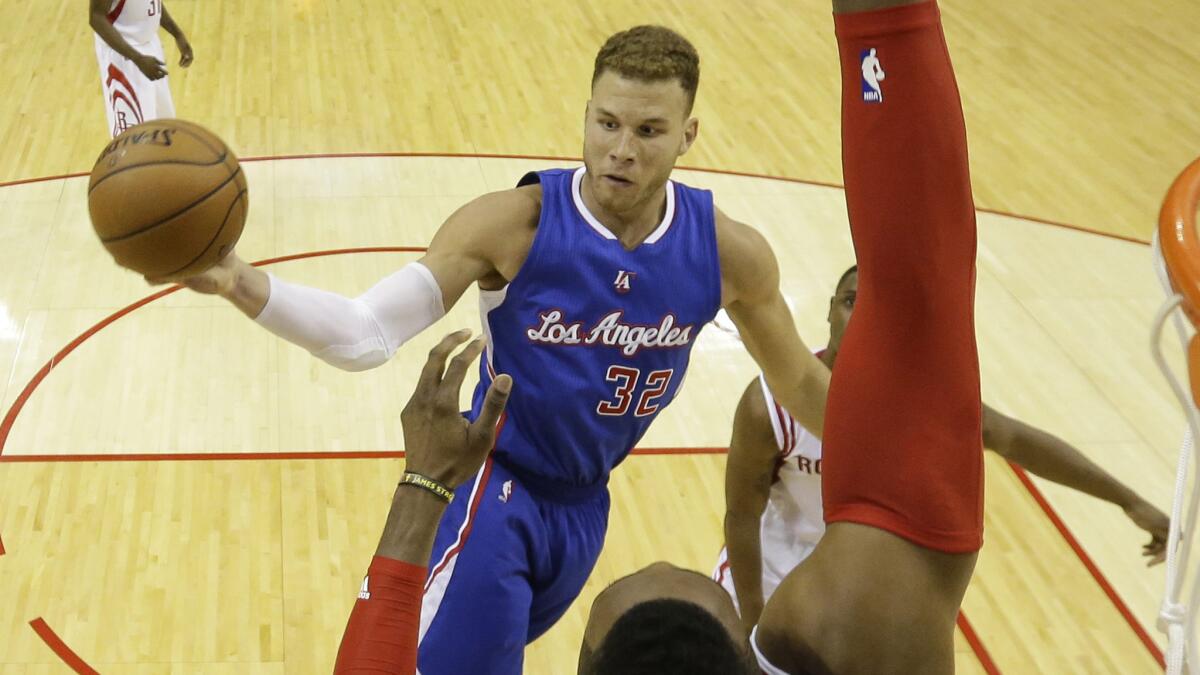 Clippers power forward Blake Griffin passes in front of Houston Rockets forward Dwight Howard during the Clippers' 117-101 victory in Game 1 of the Western Conference semifinals on May 4, 2015.